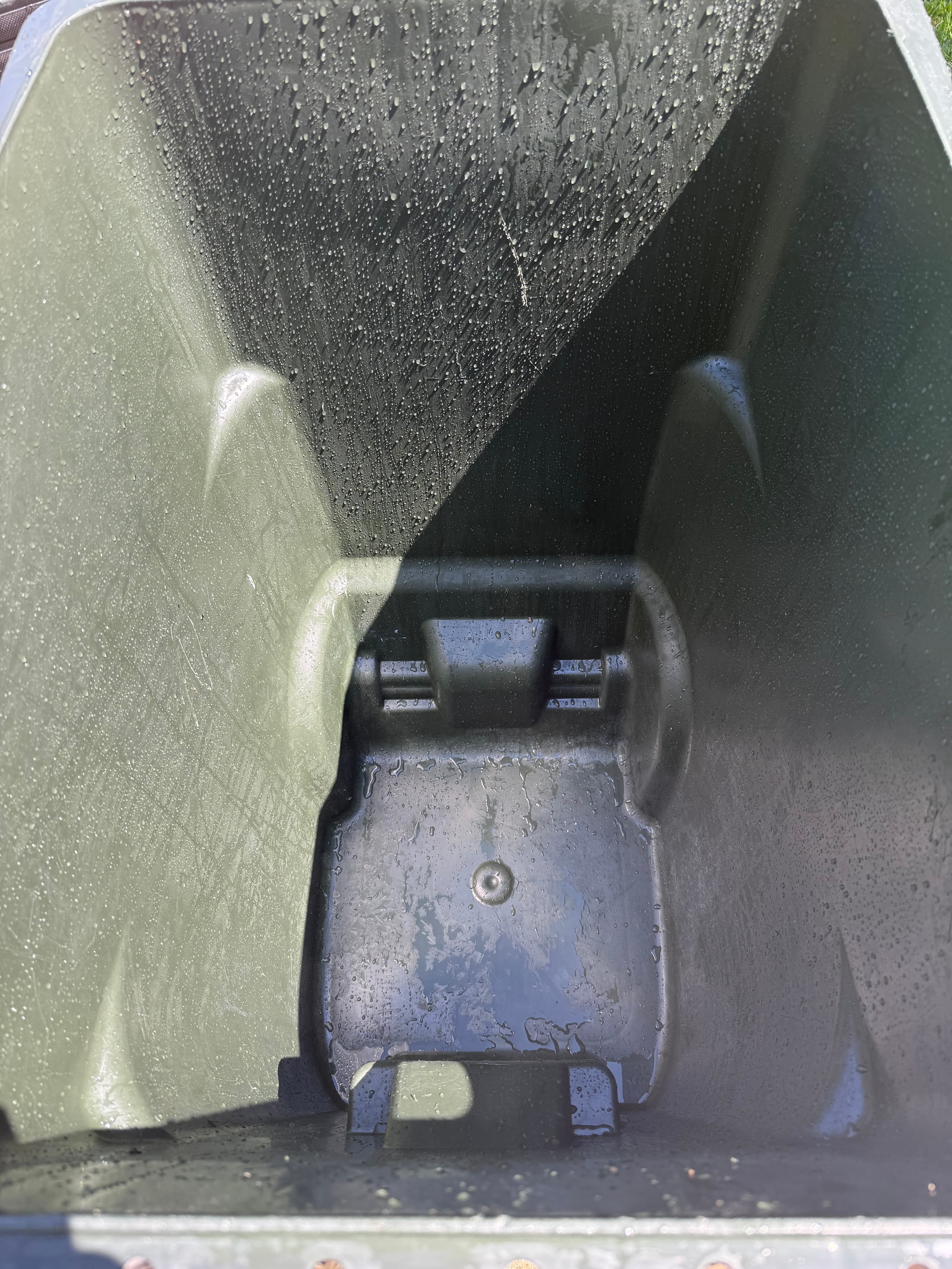 Inside view of a garbage bin after rinsing and cleaning.