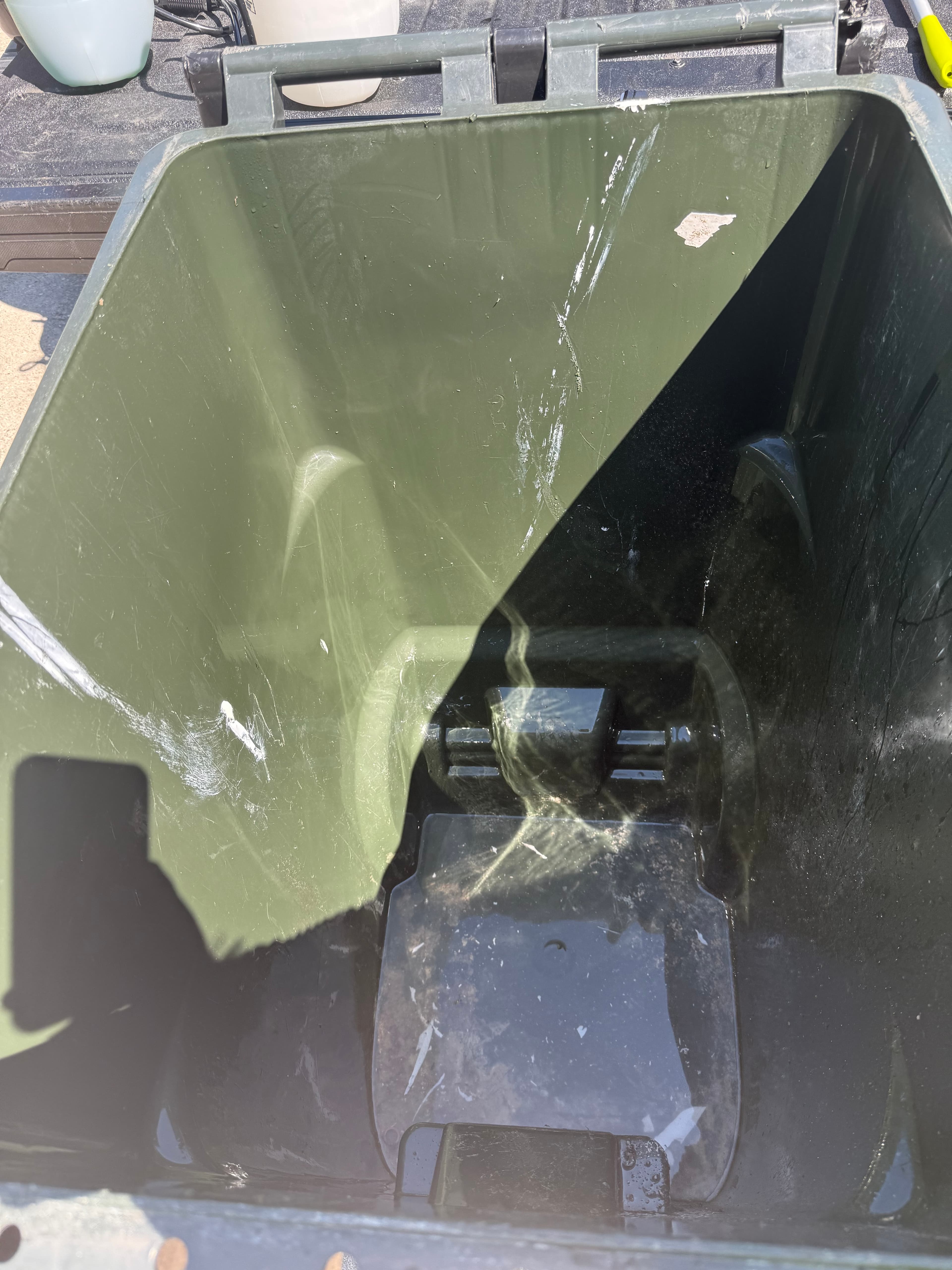 Inside view of a garbage bin before detailed cleaning.